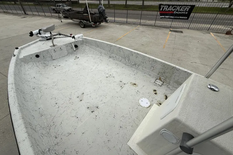 Slide: The Image of 1991 Avenger 210 Bay Runner boat interior with trolling motor, parked outdoors. - 9