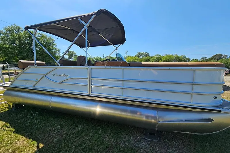 The Image of 2026 Bentley Pontoons Legacy 223 QSB pontoon boat with canopy, parked on grass. - 1