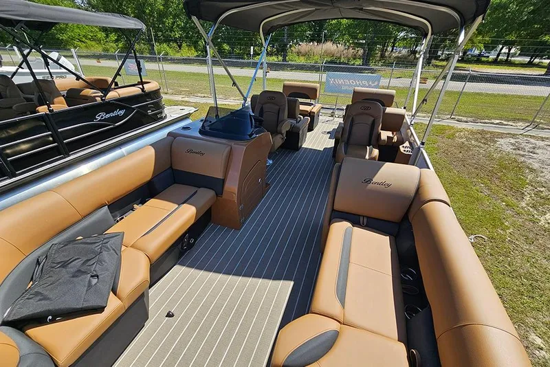 Slide: The Image of 2026 Bentley Pontoons Legacy 223 QSB interior with luxurious tan seating and spacious layout. - 11