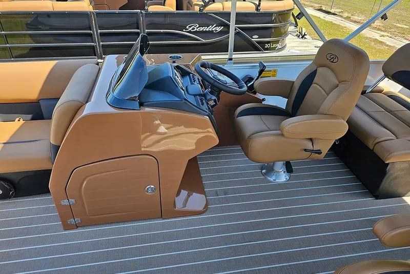 Slide: The Image of 2026 Bentley Pontoons Legacy 223 QSB interior with tan seating and modern helm controls. - 17