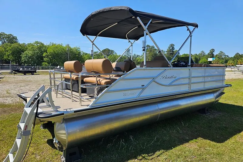 Slide: The Image of 2026 Bentley Pontoons Legacy 223 QSB pontoon boat with canopy, parked on grass. - 3