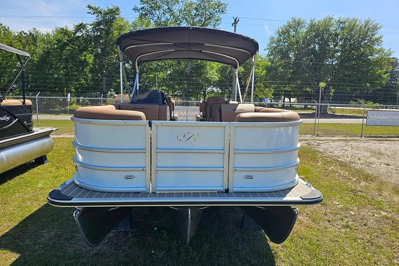 Slide: The Image of 2026 Bentley Pontoons Legacy 223 QSB on grass, showcasing rear view and seating. - 4