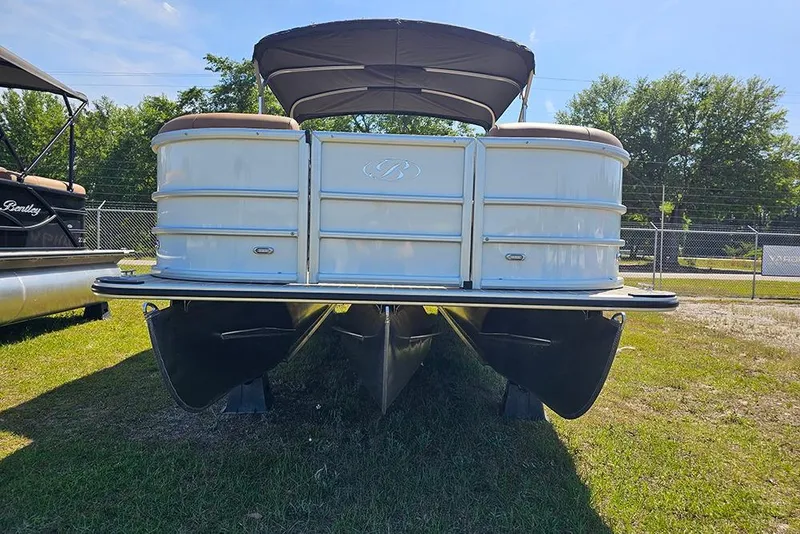 Slide: The Image of 2026 Bentley Pontoons Legacy 223 QSB on display, front view with canopy, outdoors. - 5