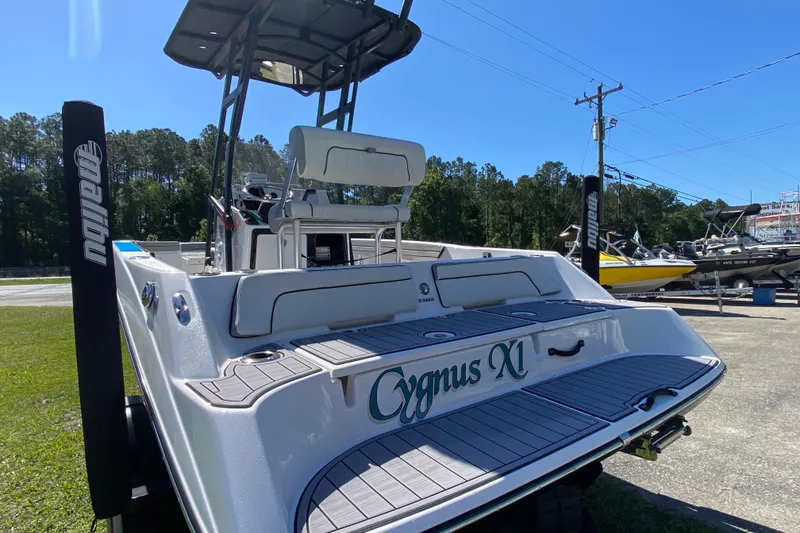 The Image of 2023 Yamaha Boats 195 FSH Sport, rear view, parked outdoors on a sunny day. - 1