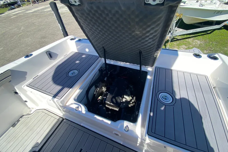 Slide: The Image of 2023 Yamaha Boats 195 FSH Sport engine compartment with open hatch, showcasing interior details. - 10
