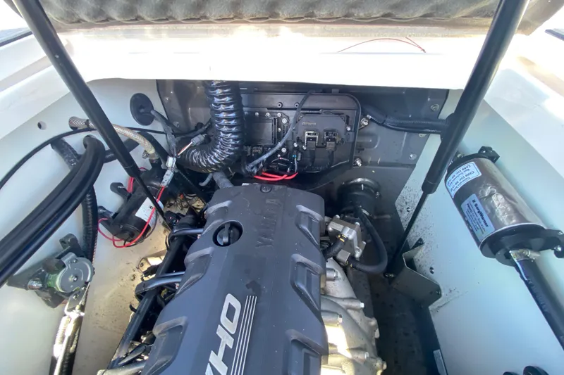 Slide: The Image of Engine compartment of 2023 Yamaha Boats 195 FSH Sport, showcasing mechanical components. - 12