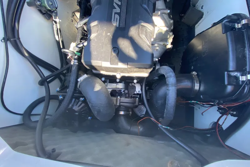 Slide: The Image of Engine compartment of 2023 Yamaha Boats 195 FSH Sport, showcasing internal components and wiring. - 13