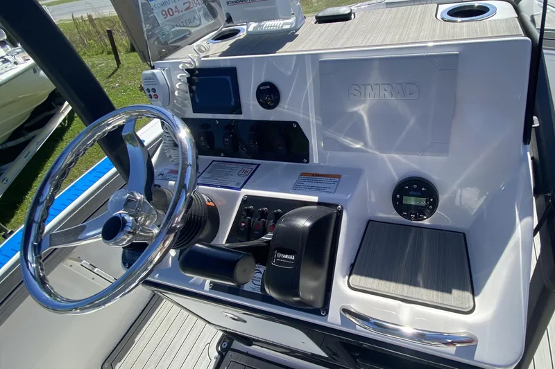 Slide: The Image of 2023 Yamaha Boats 195 FSH Sport dashboard with steering wheel and controls. - 7