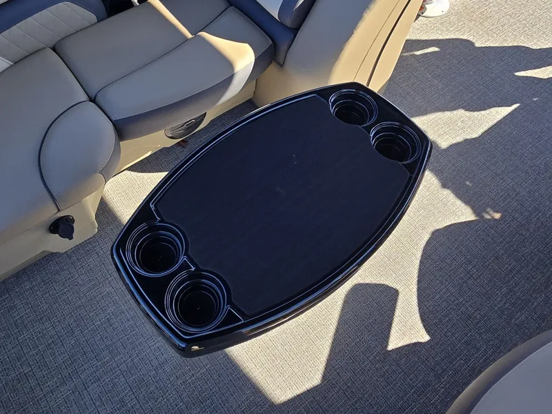 Slide: The Image of A sleek table with cup holders on a boat with comfortable seating. - 10