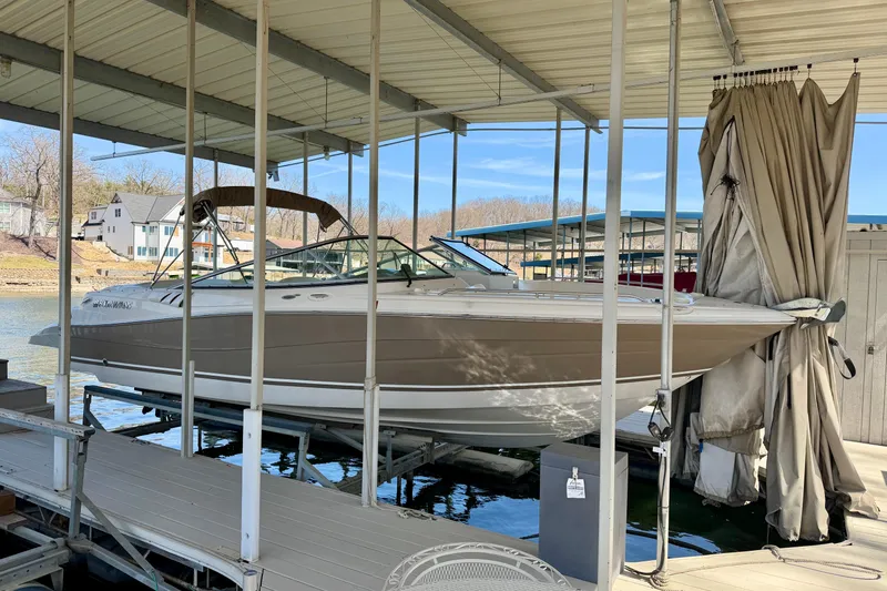 The Image of 2004 Four Winns 280 Horizon boat docked under covered marina. - 0