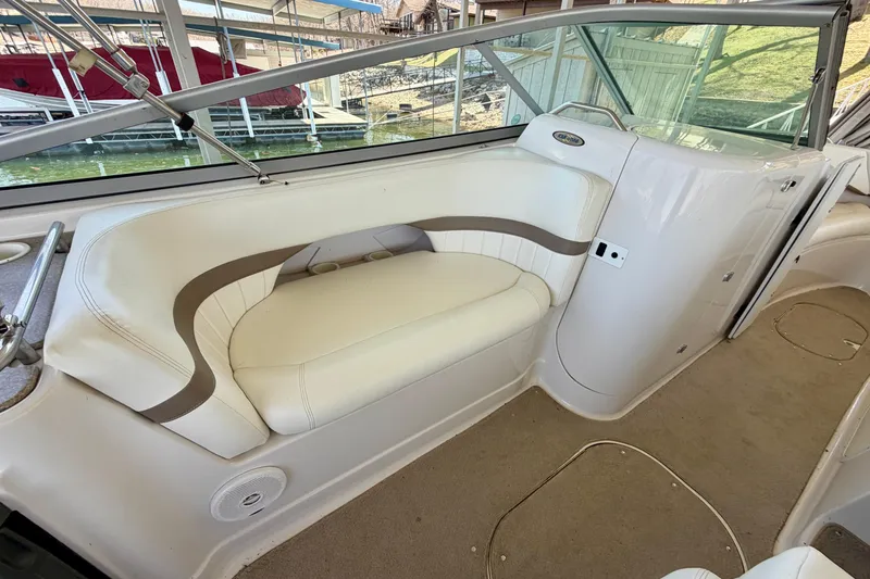 Slide: The Image of 2004 Four Winns 280 Horizon boat interior with white seating and carpeted floor. - 11