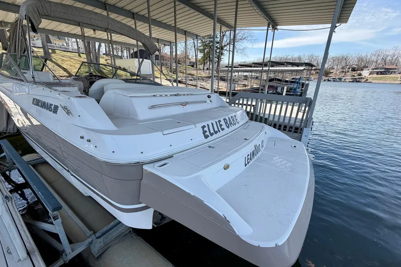 Slide: The Image of 2004 Four Winns 280 Horizon boat docked by a serene lakeside. - 2