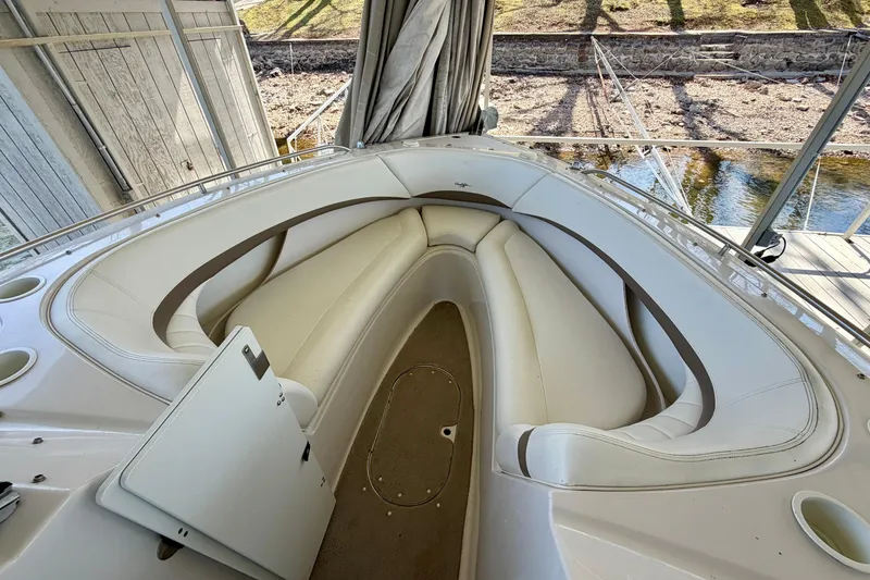 Slide: The Image of 2004 Four Winns 280 Horizon boat interior with white seating and storage compartment. - 20
