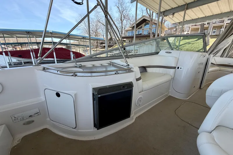 Slide: The Image of 2004 Four Winns 280 Horizon boat interior with seating and mini fridge. - 8
