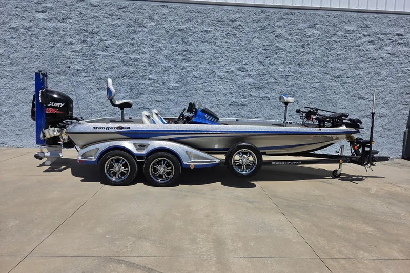 The Image of 2017 Ranger Z521 Comanche fishing boat on trailer, parked outdoors against a gray wall. - 0