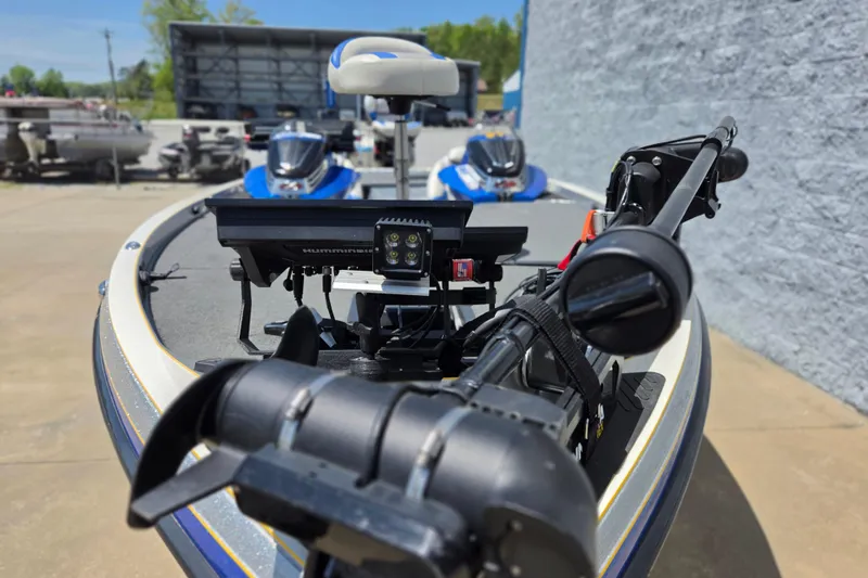 Slide: The Image of 2017 Ranger Z521 Comanche boat with advanced fishing equipment and motor, parked outdoors. - 4