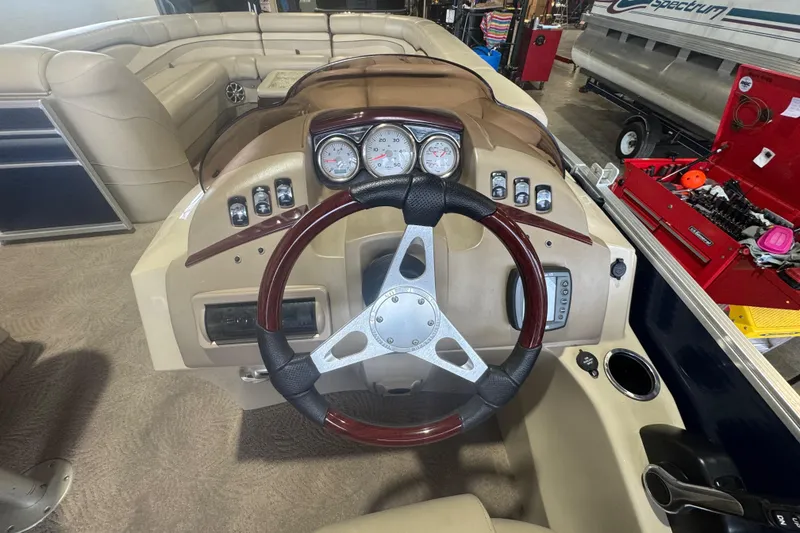 Slide: The Image of Steering console of a 2010 Bennington 2550RCW pontoon boat with gauges and controls. - 17