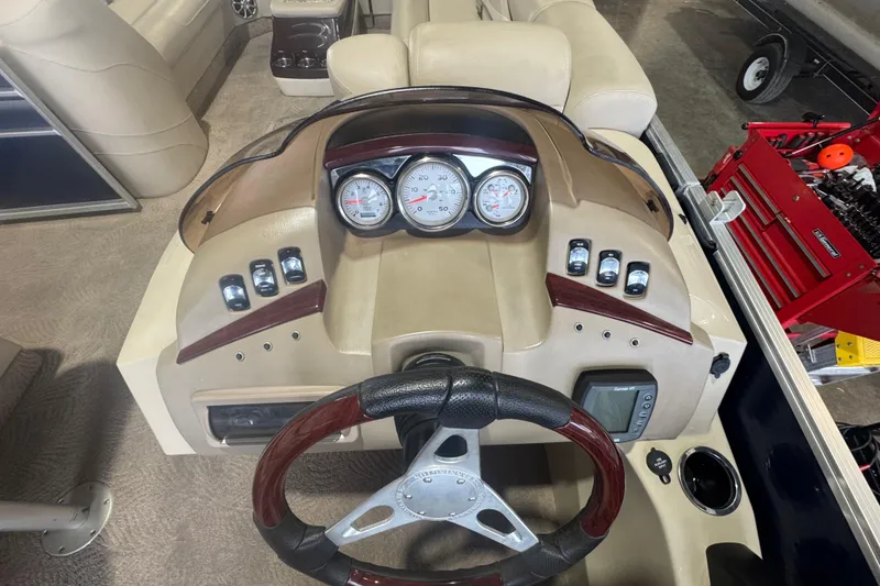 Slide: The Image of Dashboard of a 2010 Bennington 2550RCW boat with gauges and controls. - 18