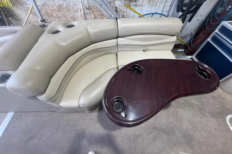 Slide: The Image of Luxurious seating and table on a 2010 Bennington 2550RCW boat interior. - 19