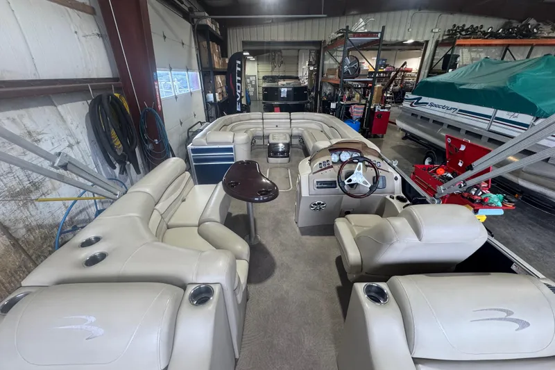Slide: The Image of Interior of a 2010 Bennington 2550RCW pontoon boat in a storage facility. - 21
