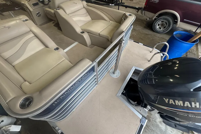 Slide: The Image of 2010 Bennington 2550RCW boat interior with Yamaha outboard motor, featuring beige seating. - 26