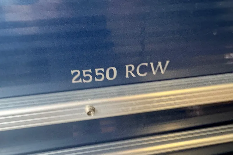 Slide: The Image of Close-up of 2010 Bennington 2550RCW model nameplate on blue surface. - 28