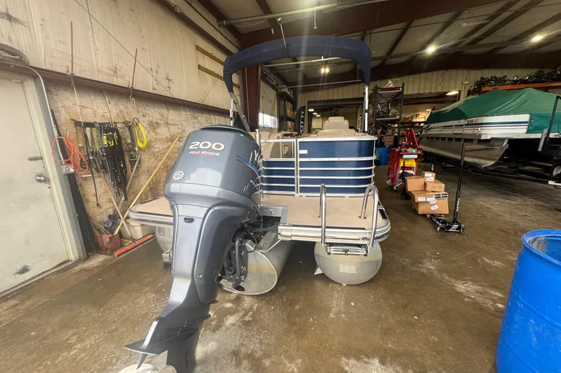 Slide: The Image of 2010 Bennington 2550RCW pontoon boat with Yamaha 200 engine in a storage facility. - 5