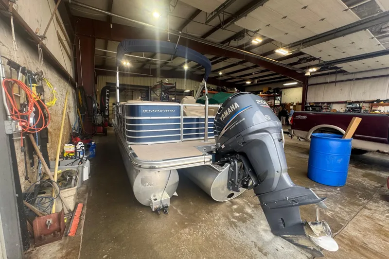 Slide: The Image of 2010 Bennington 2550RCW pontoon boat with Yamaha outboard motor in a garage setting. - 6