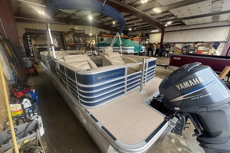 Slide: The Image of 2010 Bennington 2550RCW pontoon boat with Yamaha engine in a workshop setting. - 7