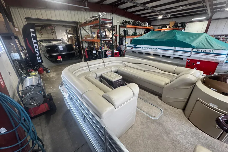 Slide: The Image of 2010 Bennington 2550RCW pontoon boat in a storage facility with other boats. - 8