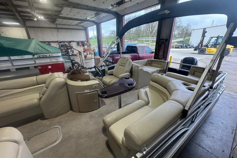 Slide: The Image of 2010 Bennington 2550RCW pontoon boat interior in a garage setting. - 9