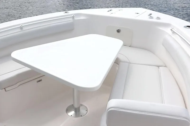 Slide: The Image of Manufacturer Provided Image: 2025 Sea Born LX26 Center Console boat interior with white seating and table. - 2