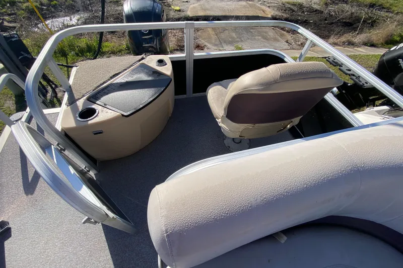 Slide: The Image of 2018 Sun Tracker Bass Buggy 18 DLX boat interior with seating and console. - 11