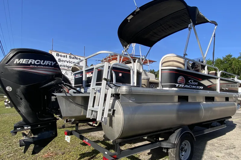 Slide: The Image of 2018 Sun Tracker Bass Buggy 18 DLX pontoon boat with Mercury outboard motor on trailer. - 4