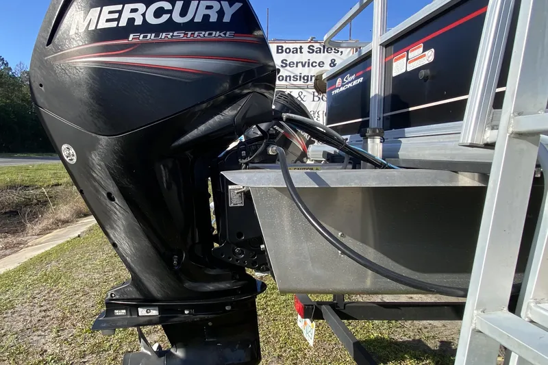 Slide: The Image of 2018 Sun Tracker Bass Buggy 18 DLX with Mercury FourStroke engine, parked outdoors. - 5