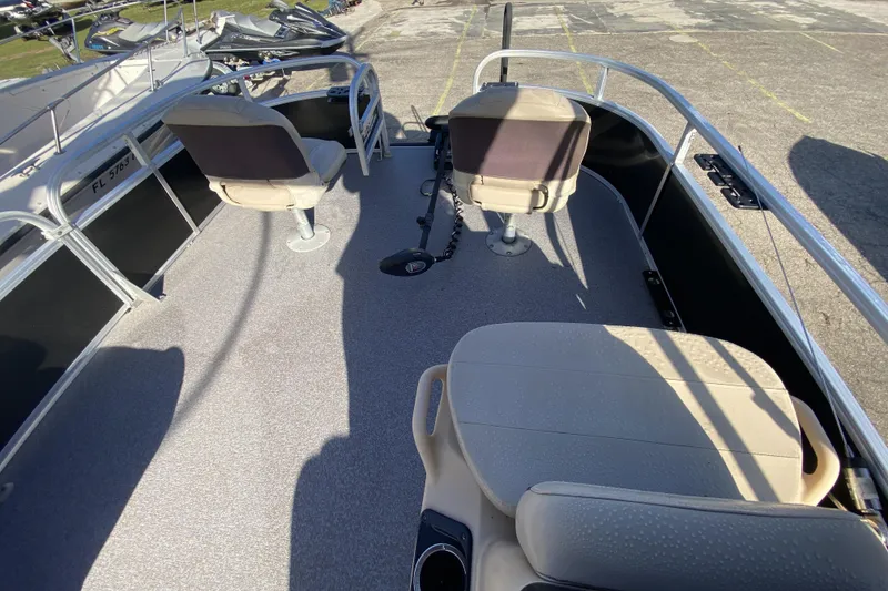 Slide: The Image of 2018 Sun Tracker Bass Buggy 18 DLX pontoon boat interior with seating and steering console. - 7