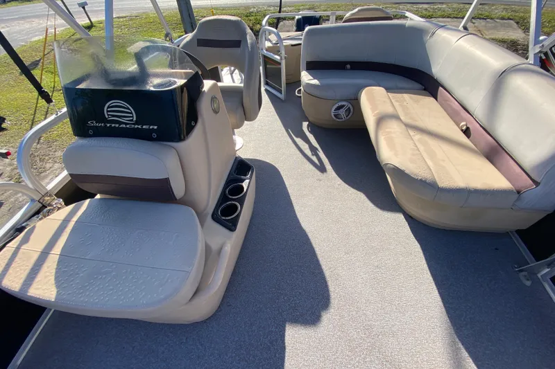 Slide: The Image of 2018 Sun Tracker Bass Buggy 18 DLX pontoon boat interior with seating and console. - 9