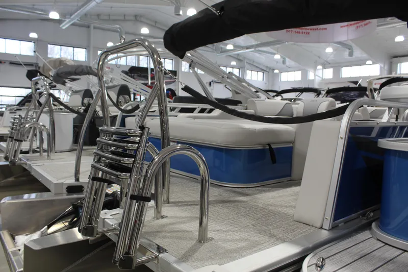 Slide: The Image of 2026 Avalon 2385 25 Venture 85 VRB pontoon boat in showroom, featuring sleek design and seating. - 12