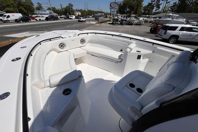 Slide: The Image of 2026 Tidewater 282 CC Adventure boat interior with white seating and cup holders. - 12