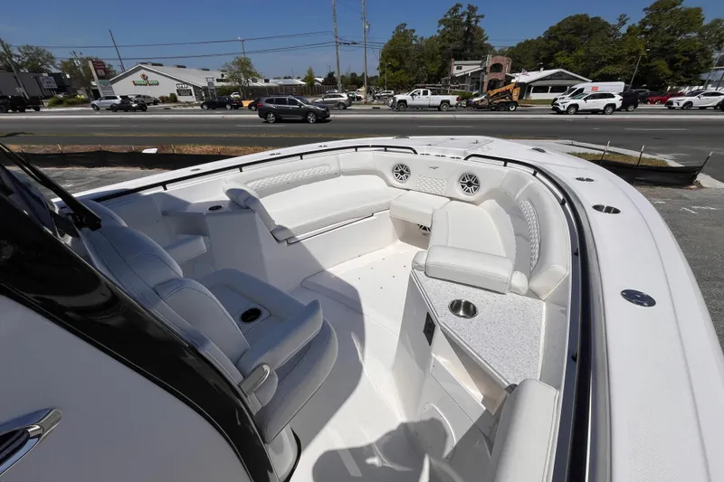 Slide: The Image of 2026 Tidewater 282 CC Adventure boat interior with white seating and cup holders. - 14