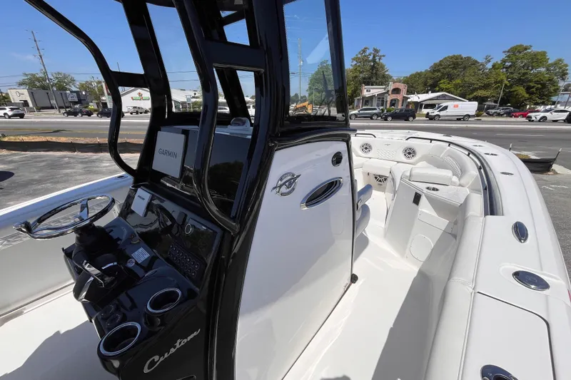 Slide: The Image of 2026 Tidewater 282 CC Adventure boat interior with steering console and seating area. - 15