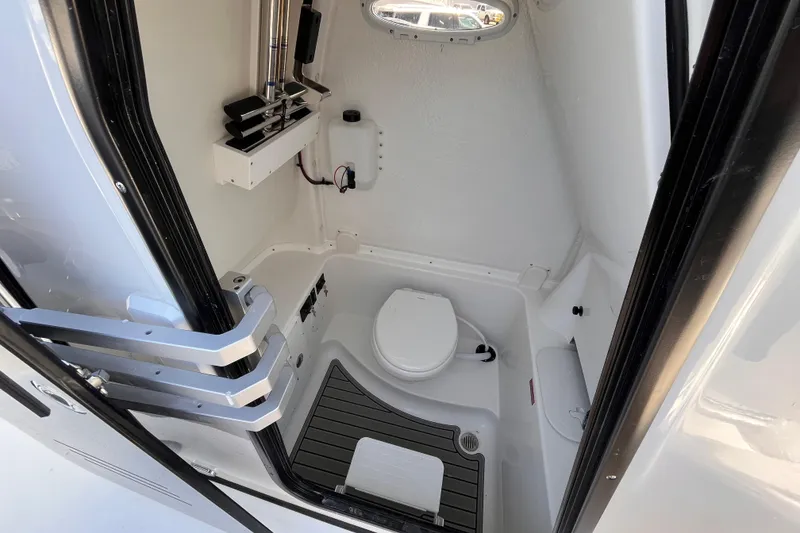Slide: The Image of Interior of 2026 Tidewater 282 CC Adventure boat's compact bathroom space. - 18