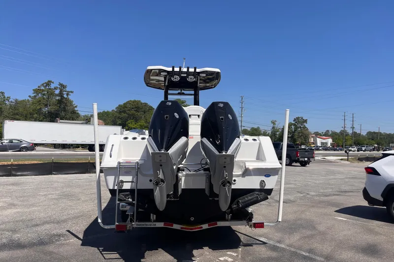 Slide: The Image of 2026 Tidewater 282 CC Adventure boat with dual outboard motors in a parking lot. - 2