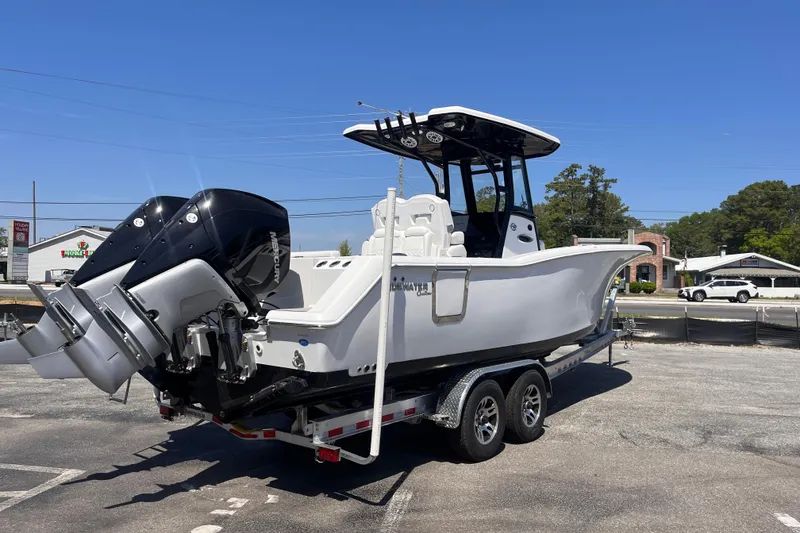 Slide: The Image of 2026 Tidewater 282 CC Adventure boat on trailer with dual outboard engines. - 3