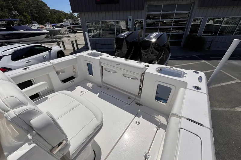 Slide: The Image of 2026 Tidewater 282 CC Adventure boat interior with dual outboard motors at a marina. - 5