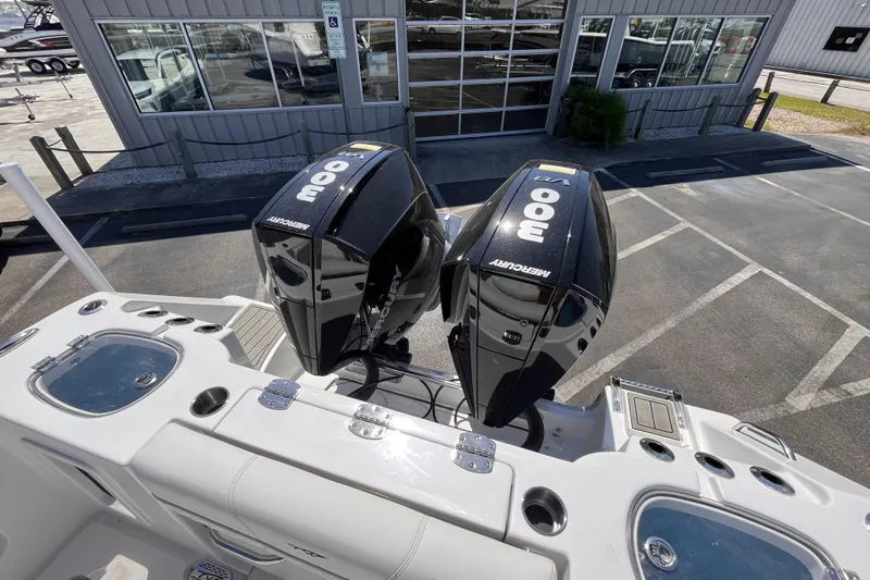 Slide: The Image of 2026 Tidewater 282 CC Adventure boat with dual Mercury 300 engines at a dealership. - 6