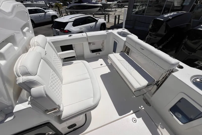 Slide: The Image of 2026 Tidewater 282 CC Adventure boat interior with white seating and modern design. - 7