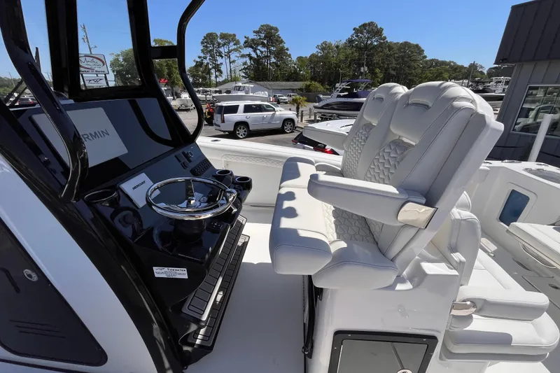 Slide: The Image of 2026 Tidewater 282 CC Adventure boat cockpit with dual seats and modern steering console. - 8