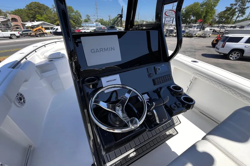 Slide: The Image of 2026 Tidewater 282 CC Adventure boat cockpit with Garmin navigation system and Mercury controls. - 9