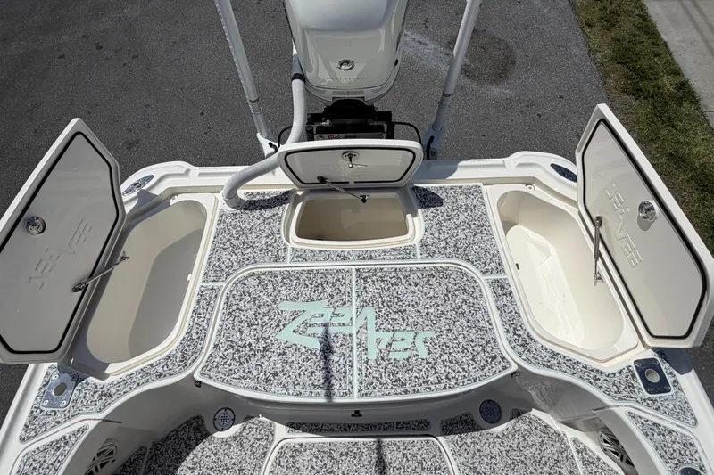 Slide: The Image of 2019 Sea Vee 270Z boat deck with open storage compartments and motor. - 11